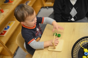 M. works on his fine motor skills after snack time.